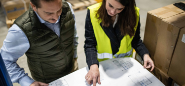 Two members check plan together on warehouse