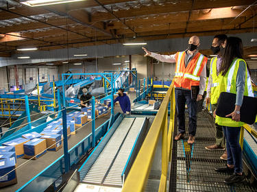 Prologis team members tour a sorting facility in Fremont, California