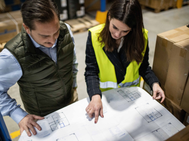 Two members check plan together on warehouse