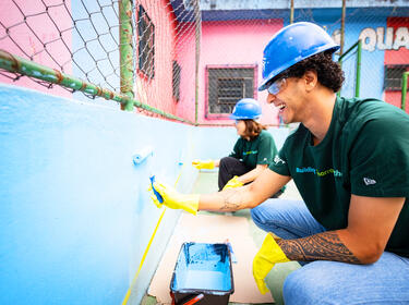 Two Prologis employees painting a wall on IMPACT Day