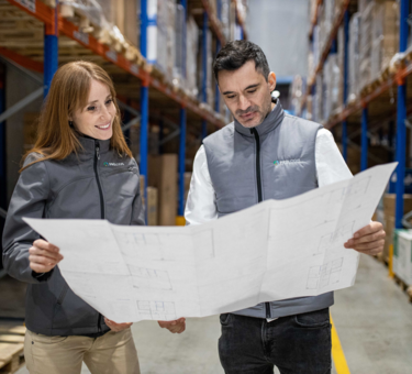 Two members check plan together on warehouse