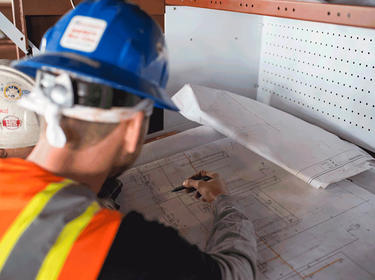 Construction workers reviewing blueprints